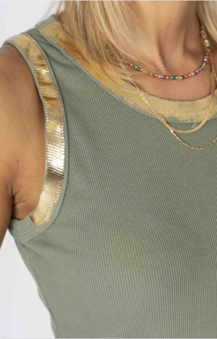 Green ribbed tank top with gold trim on a white background