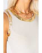 Close-up of a person wearing a gold necklace with a white background