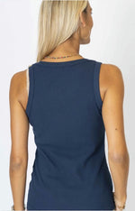 Navy blue sleeveless top worn by a person on a white background