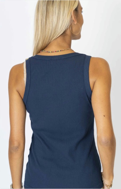 Navy blue sleeveless top worn by a person on a white background