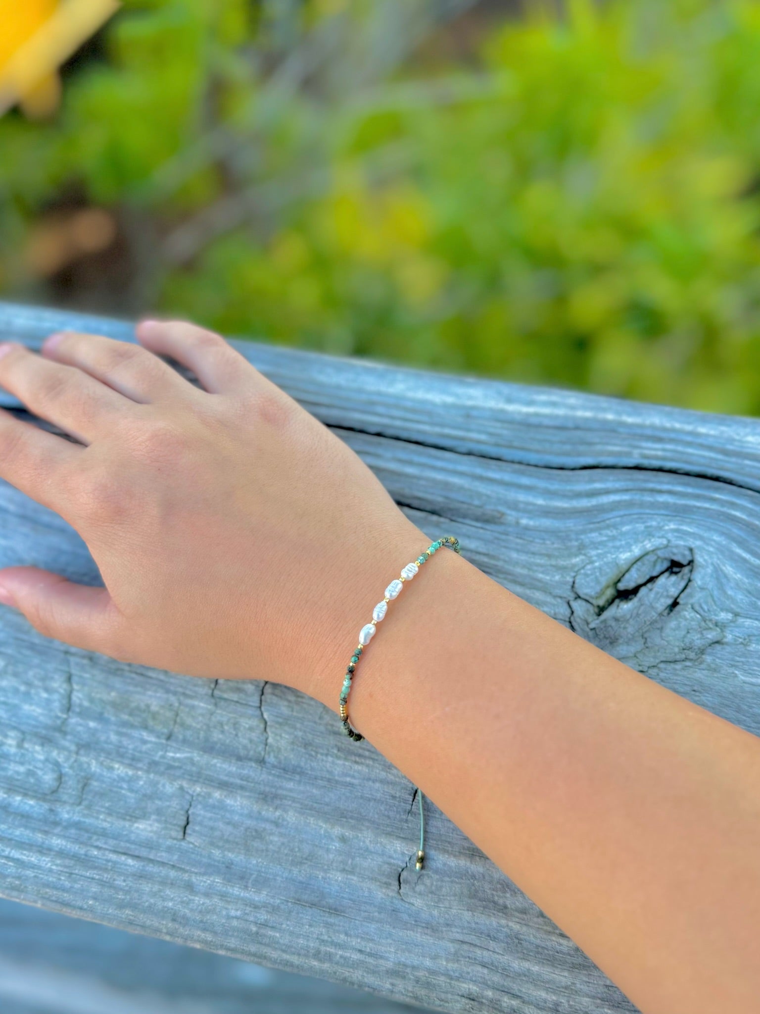 Amina African Turquoise & Freshwater Pearl Bracelet shown on model's wrist