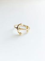 Gold ring on a light gray background