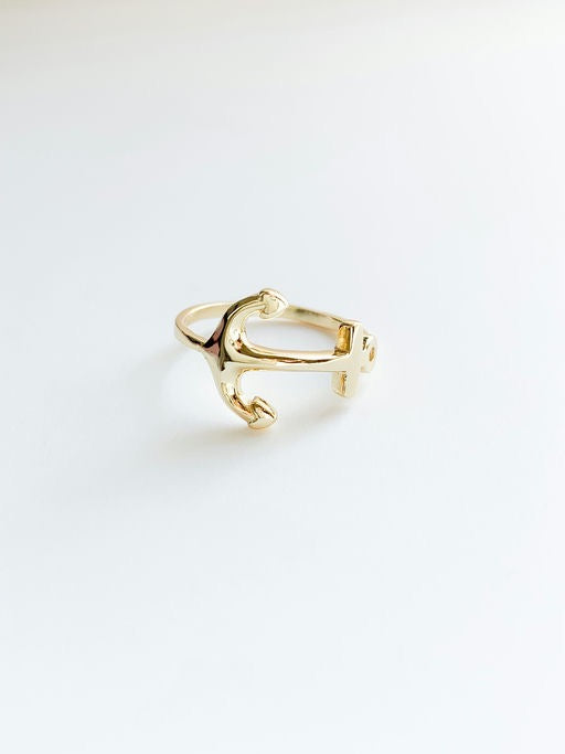 Gold ring on a light gray background