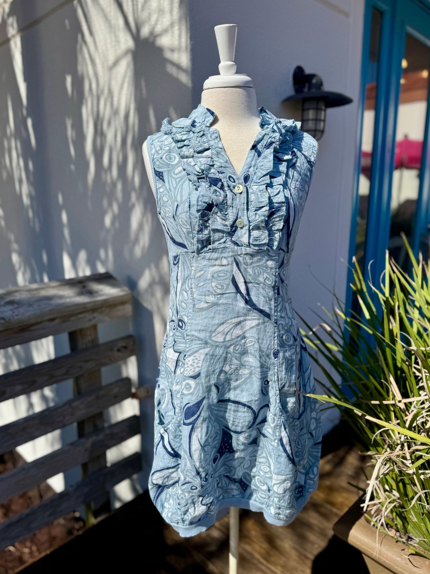 Anna Beige Navy and light blue floral dress shown on mannequin