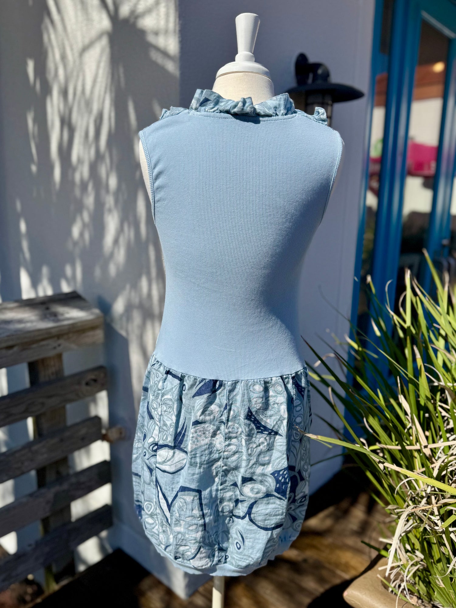 Anna Beige Navy and light blue floral dress on mannequin back view