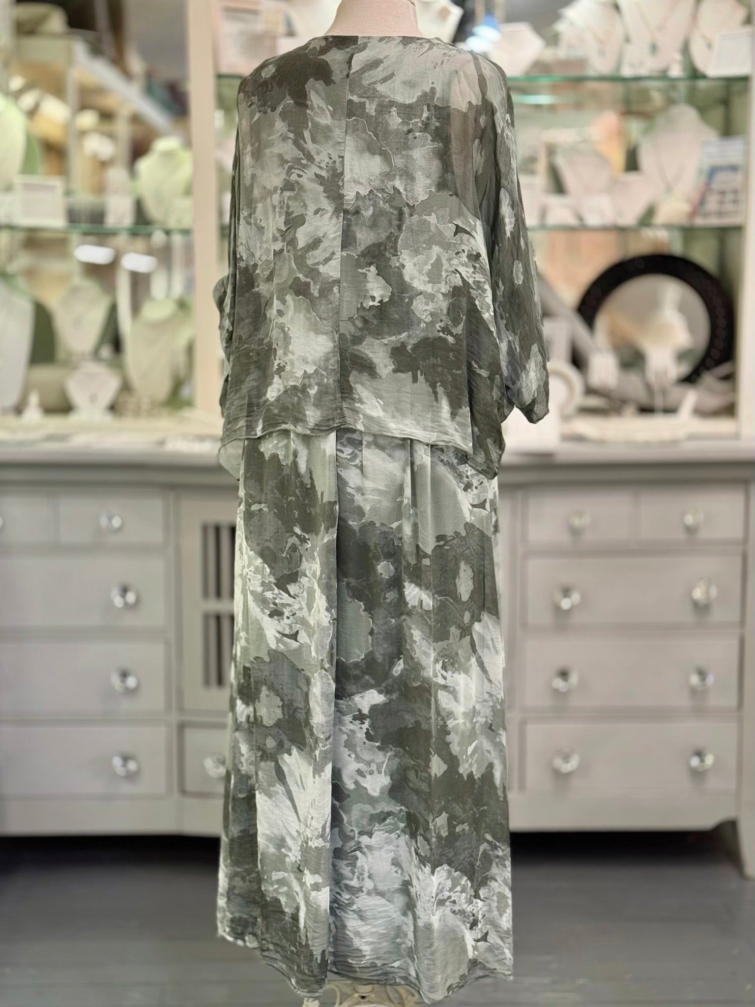 Back view of the Ariella Silk Dress in Olive tie-dye silk showing the draped overlay and flowing skirt 