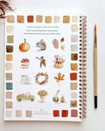 Back of Autumn Watercolor Workbook by Emily Lex displaying twelve finished fall watercolor illustrations like pumpkins, leaves, wreaths, and cozy scenes.