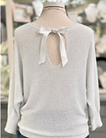 Back view of Briella white shimmer sweater with ribbon bow and silver metallic threading