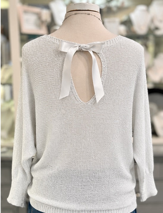 Back view of Briella white shimmer sweater with ribbon bow and silver metallic threading