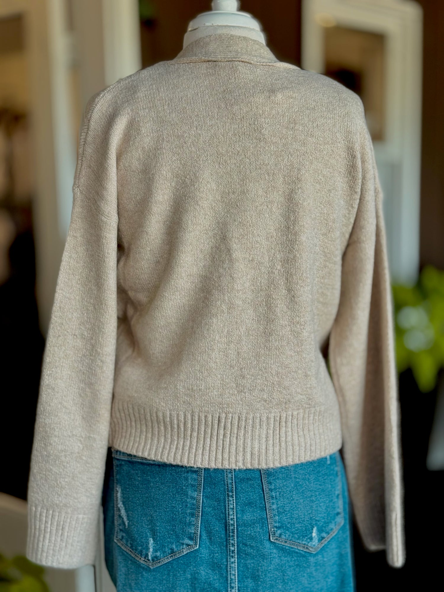 Back view of Jody Button Cardigan in sand showing cozy knit fabric and ribbed hem.