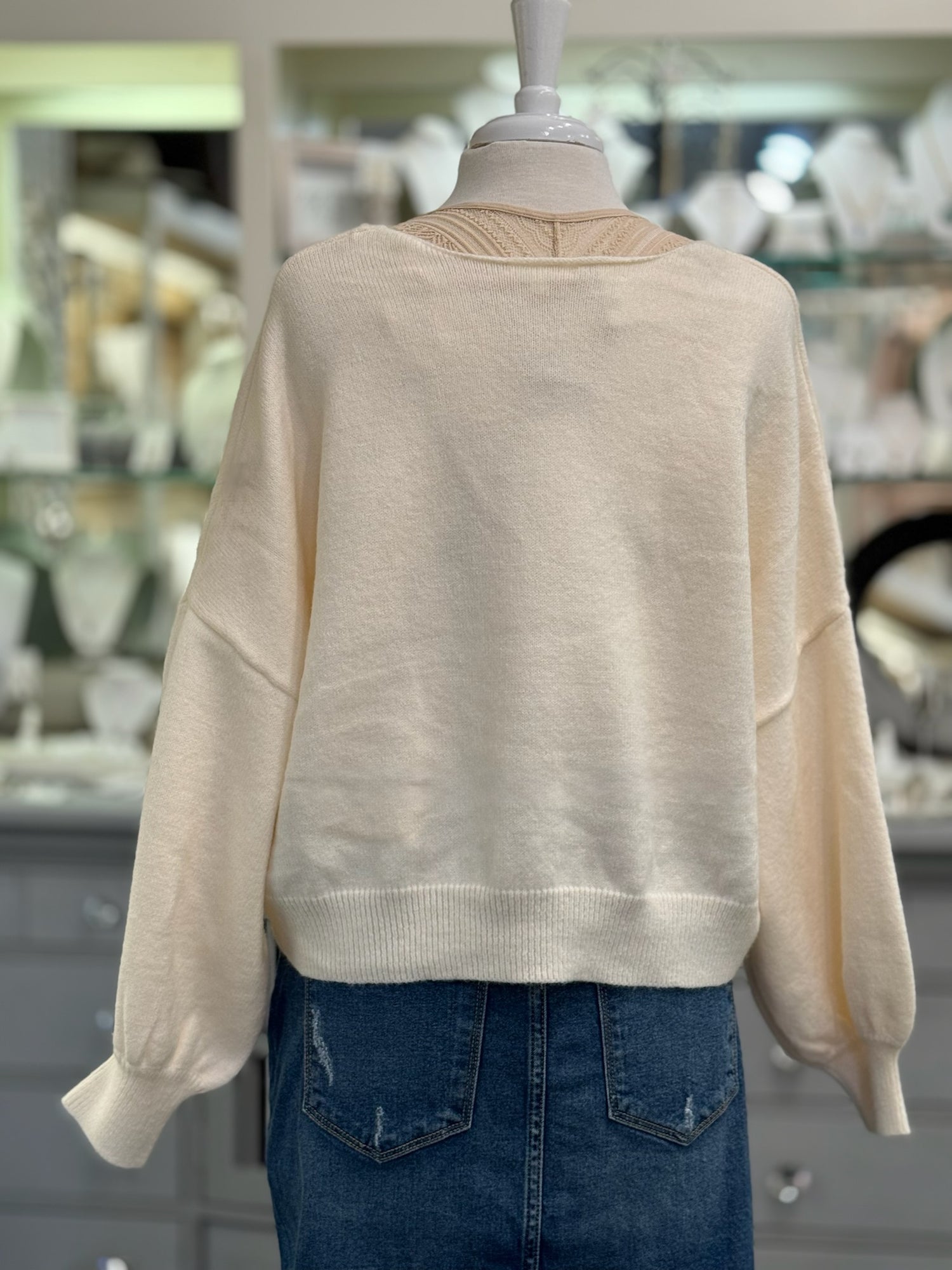 Back view of Ren Reversible Cropped Sweater in cream when V is in front