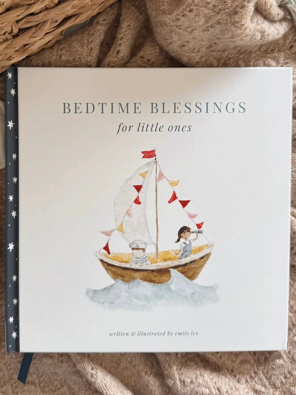 Children's book titled 'Bedtime Blessings for little ones' with a sailboat illustration on a soft fabric background.