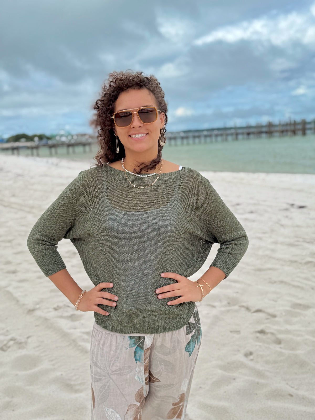 Briella Made in Italy bow back sweater front  on a model by beach