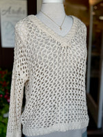 Front view of the Bree Open Knit Sweater in beige featuring an airy open-knit design, V-neckline and relaxed fit at Ardor Boutique. Styled over beige tank