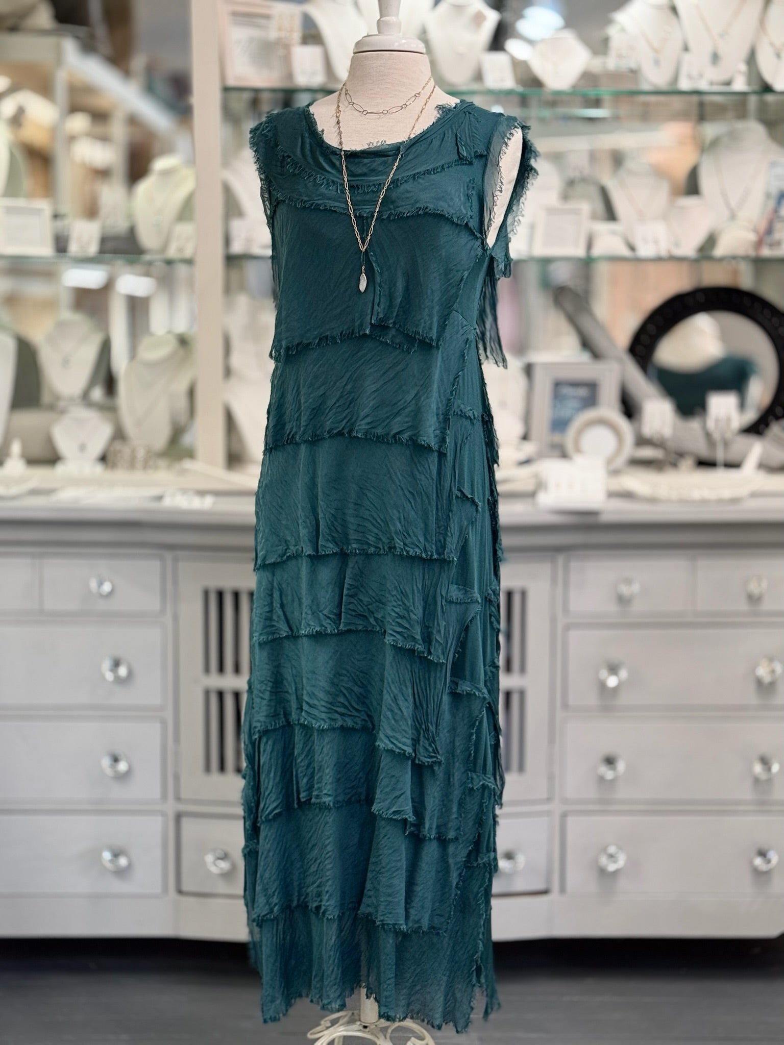 Full-length view of the Italian-made Briella Dress in peacock green, one-size fit for timeless elegance. Paired with layered necklaces