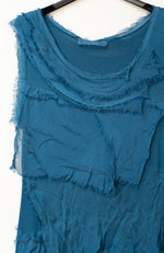 Close-up of the neckline and texture of the Briella Silk Dress highlighting its soft Italian silk layers.
