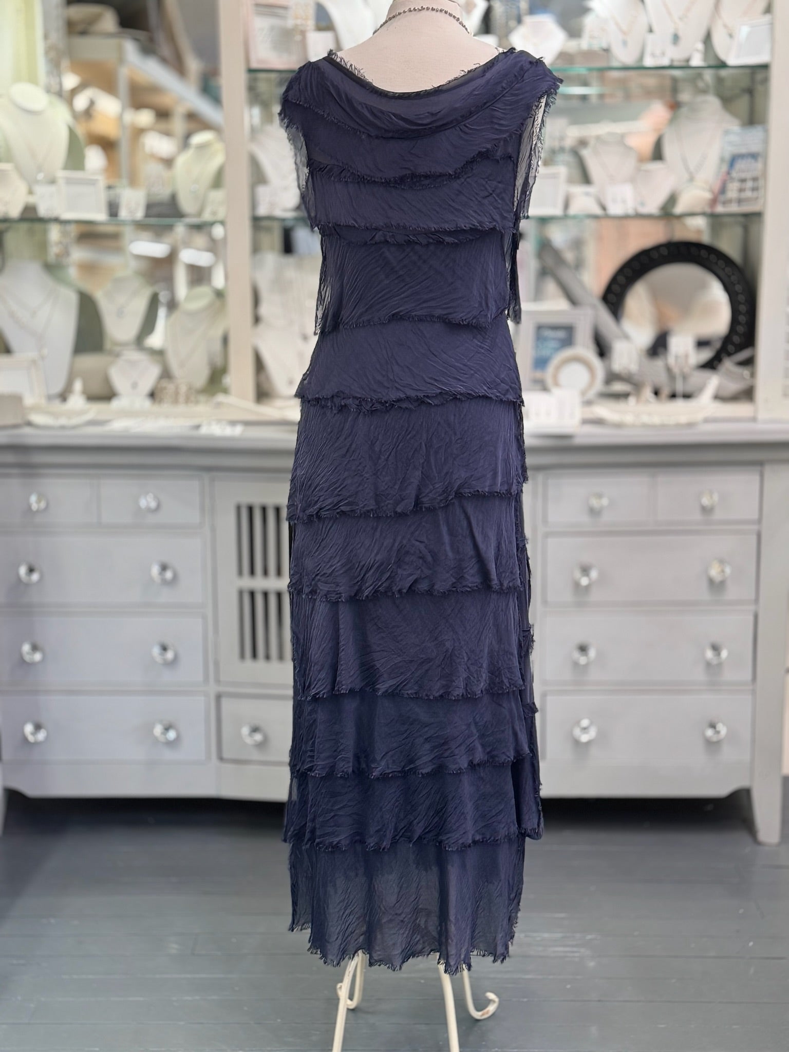 Back view of the Briella Silk Dress in navy showing the layered silk texture and graceful drape.