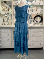 Blue tiered dress on a mannequin paired with short aquamarine Nina Halls necklace