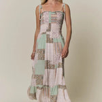 Patchwork dress with floral patterns on a neutral background