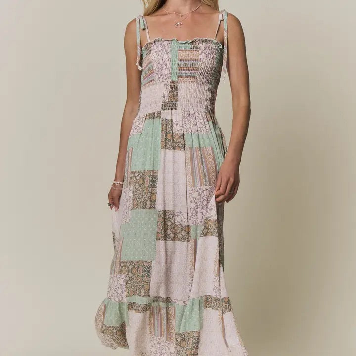 Patchwork dress with floral patterns on a neutral background