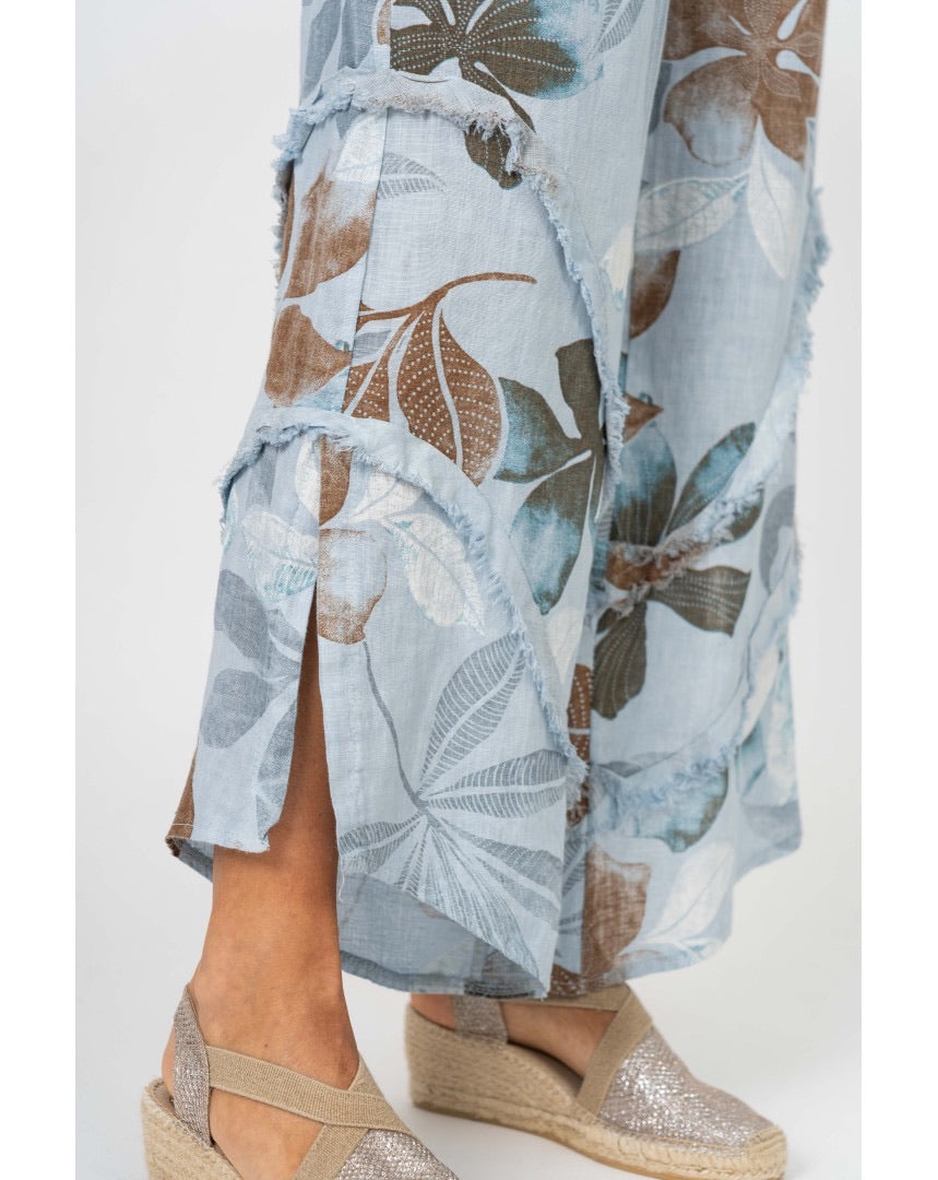 Catherine pants in light blue. Close up detail shot of leg slit and frayed ruffle detail