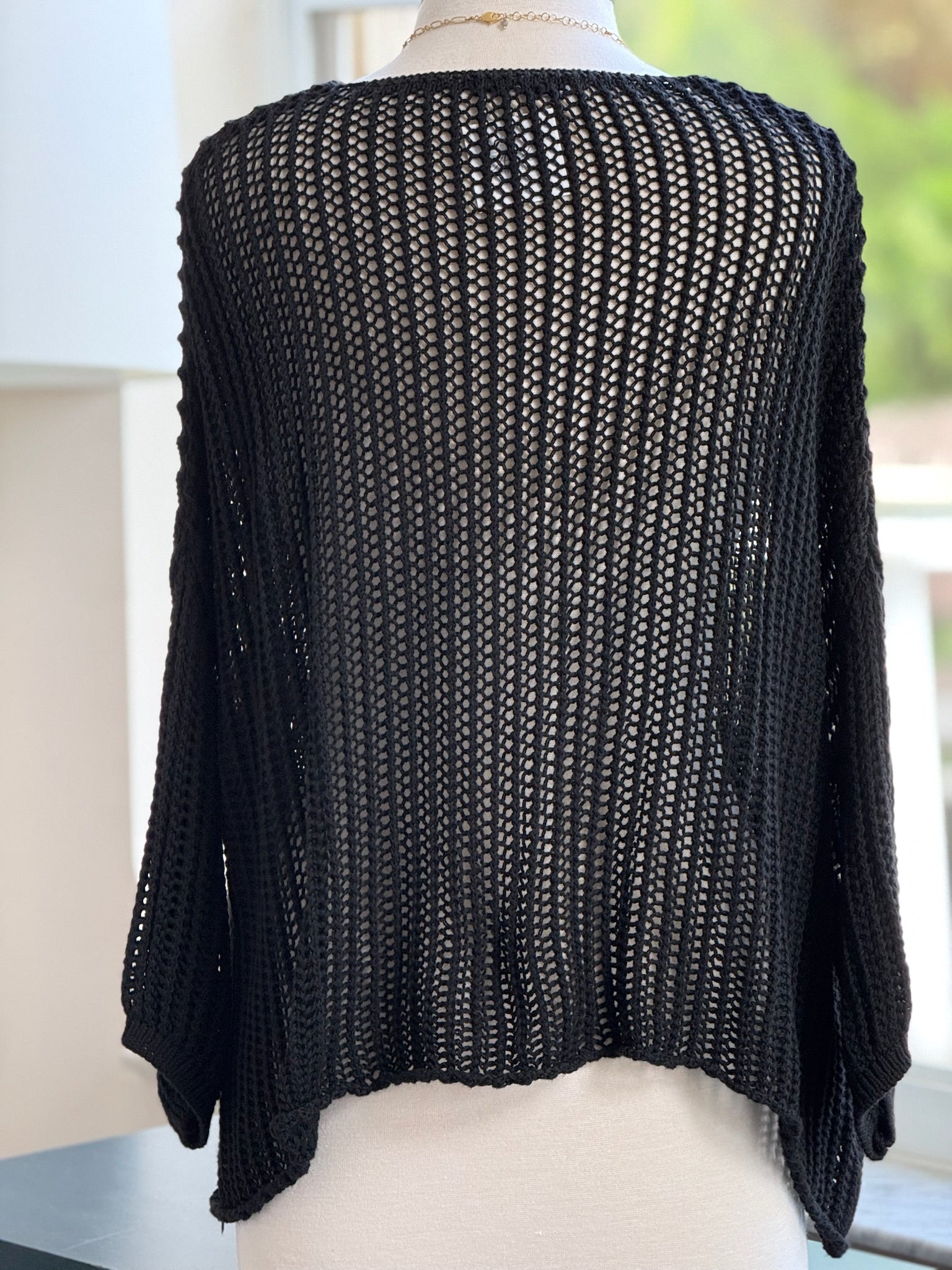 Cecilia crochet sweater in black shown on mannequin back view 