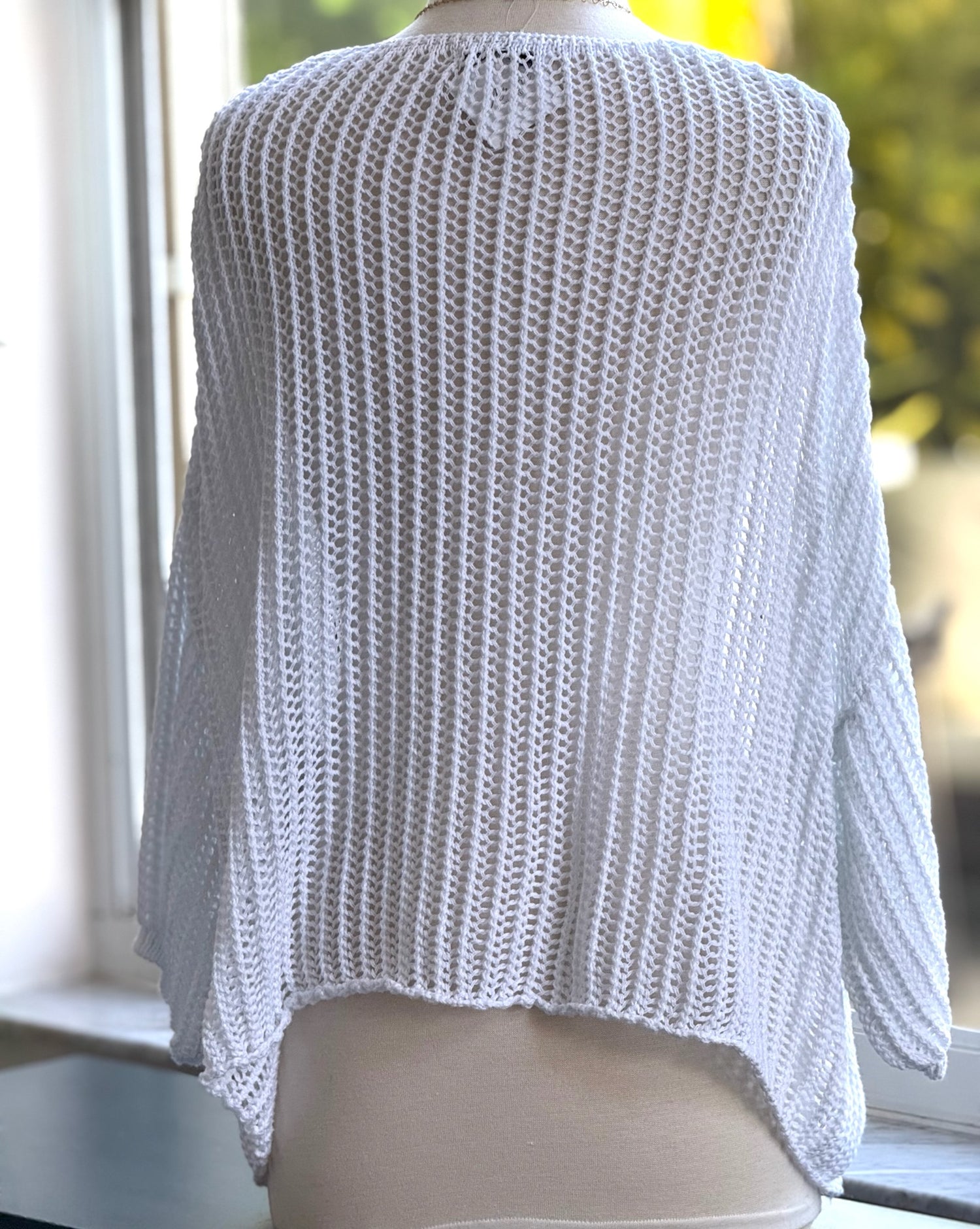 Cecilia crochet sweater in white shown on mannequin back view 