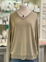 Mannequin wearing The Celeste Top in mocha, a lightweight metallic knit sweater with soft shimmer and ribbed V-neckline.
