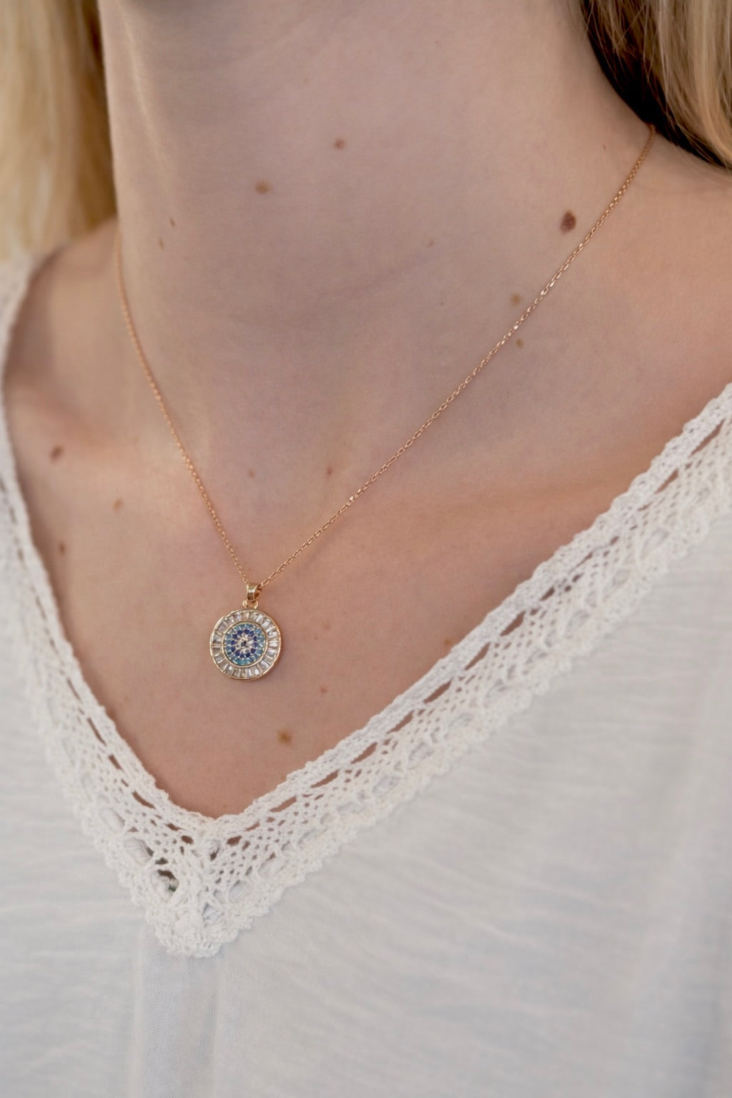 Necklace with a pendant worn by a person on a white background