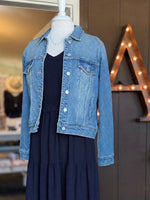 Macy Denim Jacket in medium wash layered over the navy Everly Dress with a delicate necklace at Ardor Boutique.