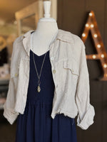 Everly Dress in navy layered with a beige linen jacket and long silver pendant necklace at Ardor Boutique.