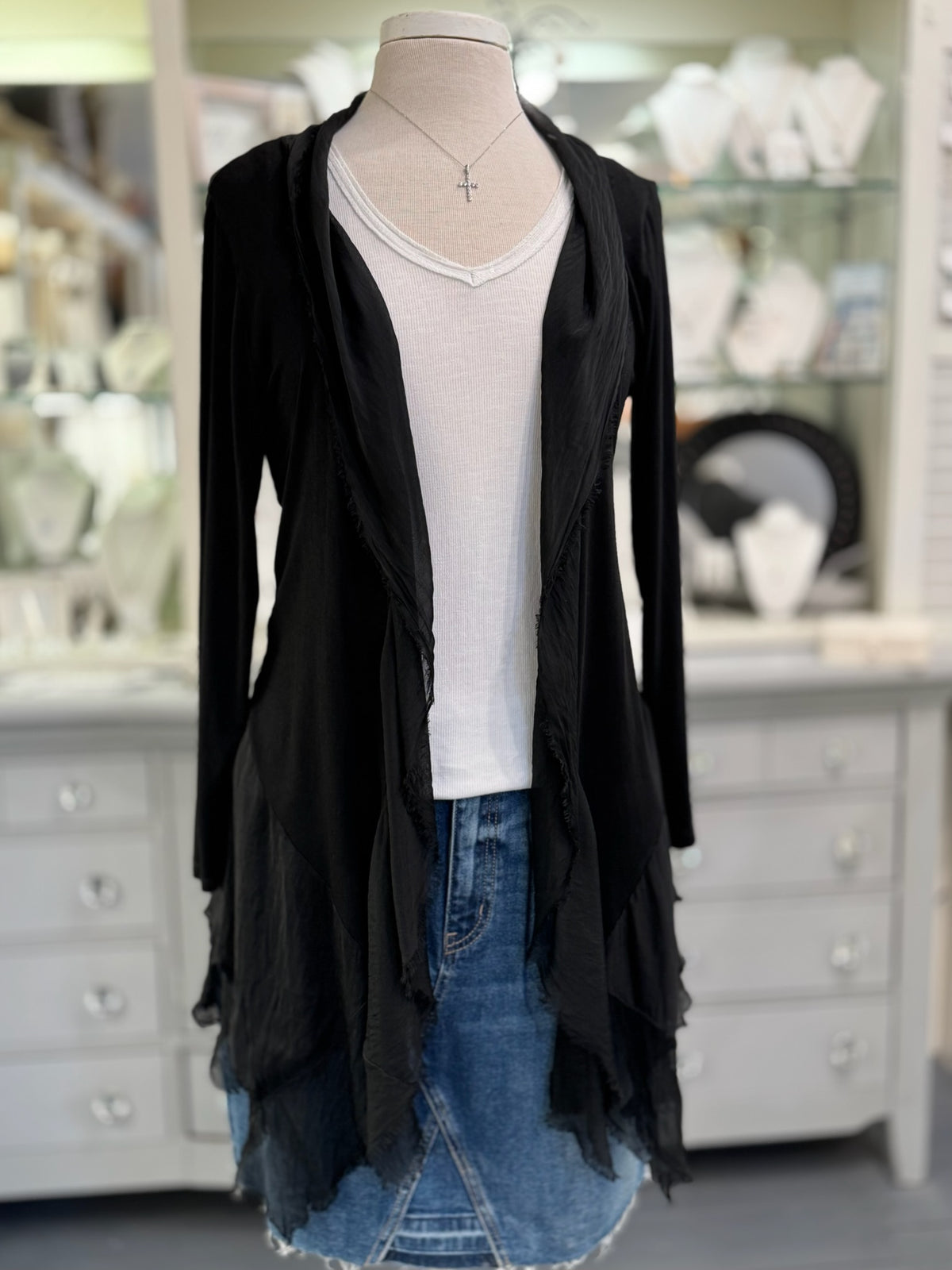 Clara Cardigan in black featuring long sleeves, a cascading open front, raw-edge detailing, and an asymmetrical hem, displayed at Ardor Boutique.
