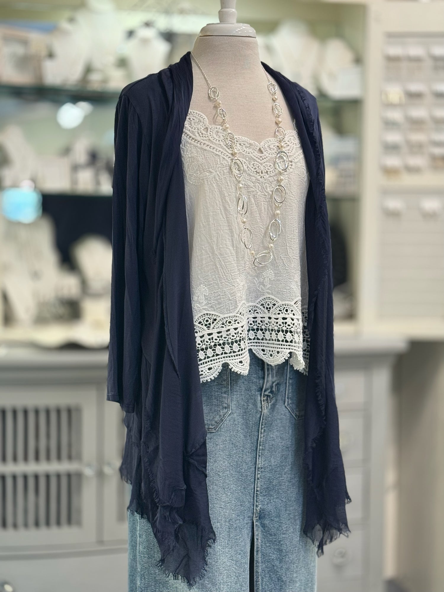 Clara Silk Cardigan in Navy over white lacy tank and denim bottoms. Paired with silver pearl necklace