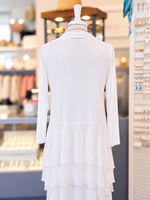 Back view of a sheer white draped cardigan displayed on a mannequin in a jewelry store