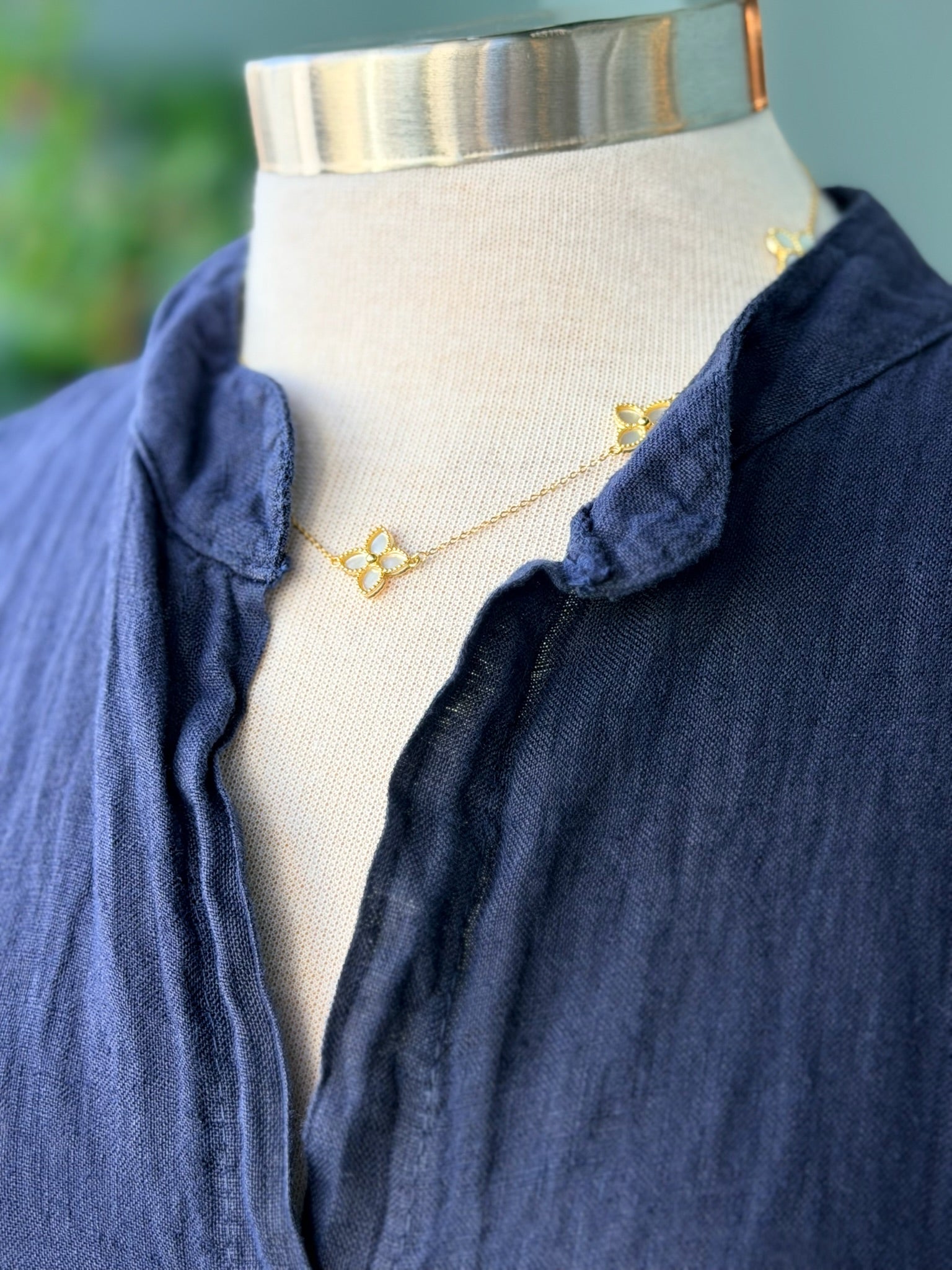 Close-up of navy linen dress neckline showing soft collar detail and fabric texture