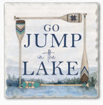 Square decorative sign with the phrase “GO JUMP in the LAKE” in navy lettering over a watercolor lake and trees background, framed by three oars with geometric Native American-style patterns.