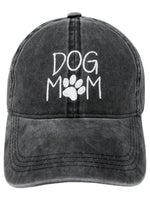 Front view of Dog Mom Cap in black with white embroidered lettering and paw print.