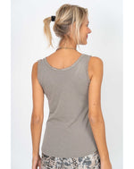 Back view of a model wearing the Elisa Sequin Tank in taupe, showing its simple sleeveless silhouette and soft cotton knit fabric.