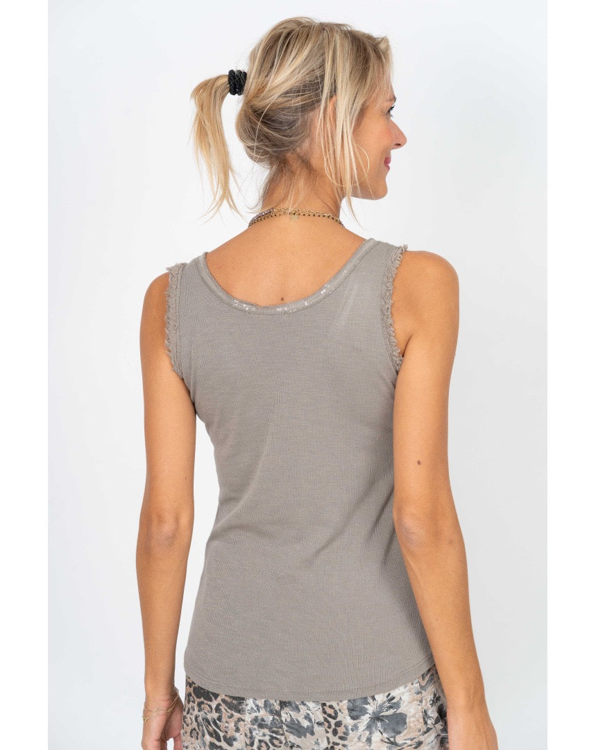Back view of a model wearing the Elisa Sequin Tank in taupe, showing its simple sleeveless silhouette and soft cotton knit fabric.