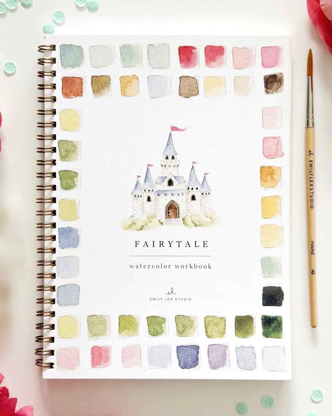 Fairytale watercolor workbook by Emily Lex with spiral binding and castle illustration on the cover surrounded by watercolor swatches