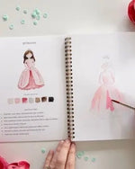 Open Fairytale watercolor workbook by Emily Lex showing princess painting lesson with step by step instructions and outlined sketch