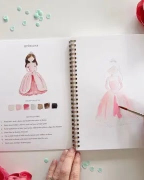 Open Fairytale watercolor workbook by Emily Lex showing princess painting lesson with step by step instructions and outlined sketch