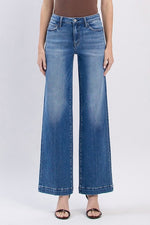 Close-up of stretch denim texture and tailored finish on wide leg Fallon jeans