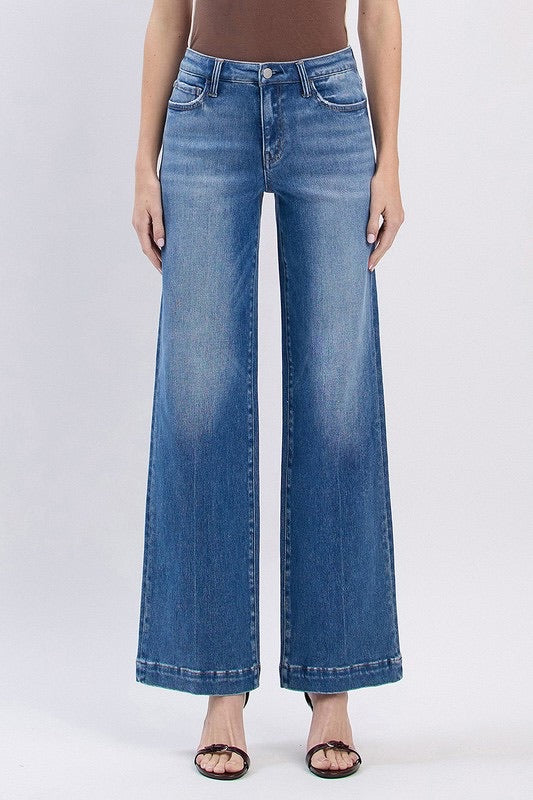 Close-up of stretch denim texture and tailored finish on wide leg Fallon jeans