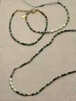 Flat lay of Nora Epidote Beaded Bracelet with Amina bracelet and Isla necklace