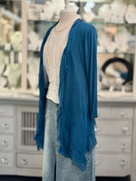 Front of Clara Silk Cardigan in Prussian blue longer in length paired with white blouse and denim bottoms