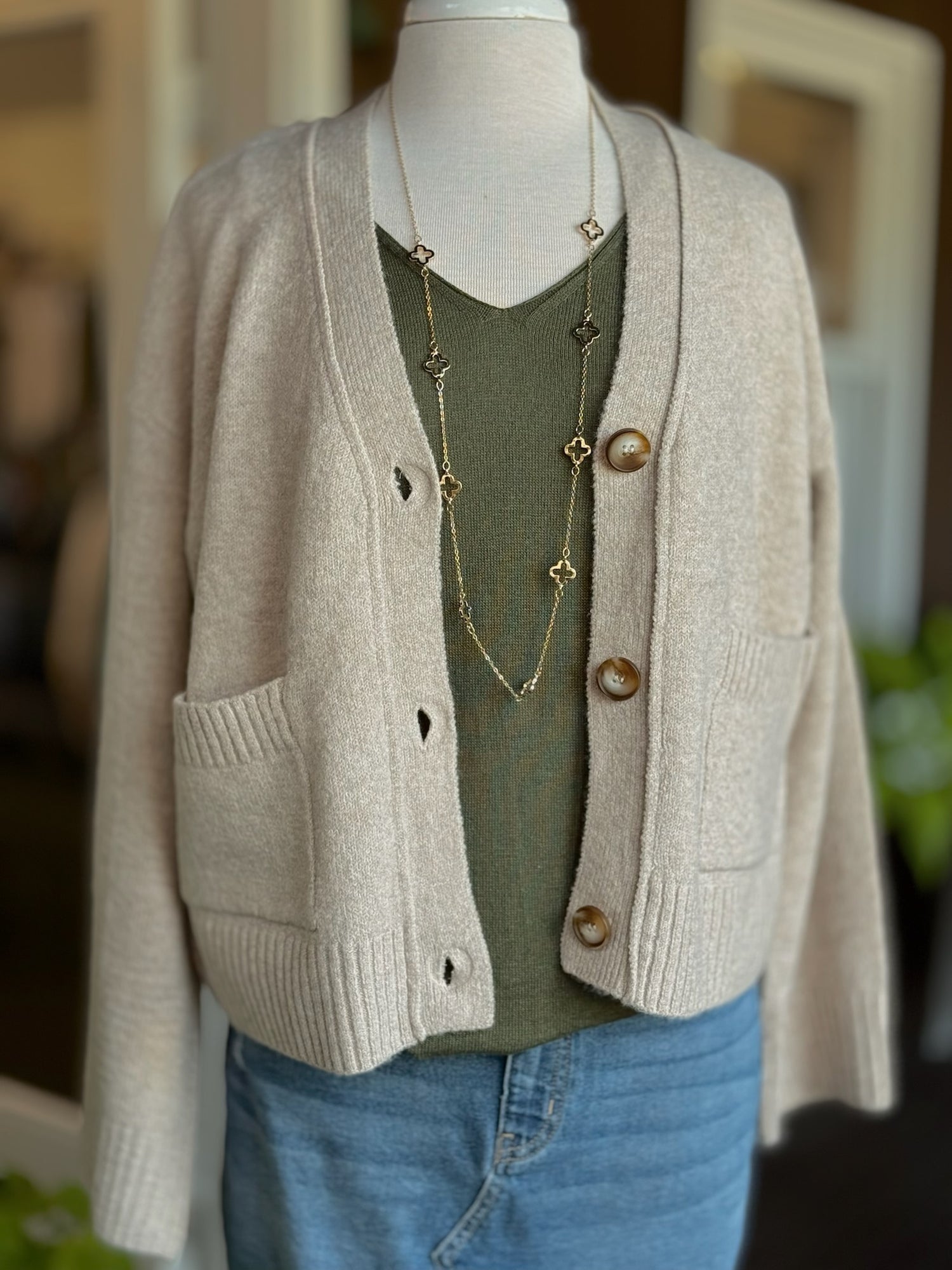 Front view of Jody Button Cardigan in sand with relaxed fit, button closure, and front pockets.