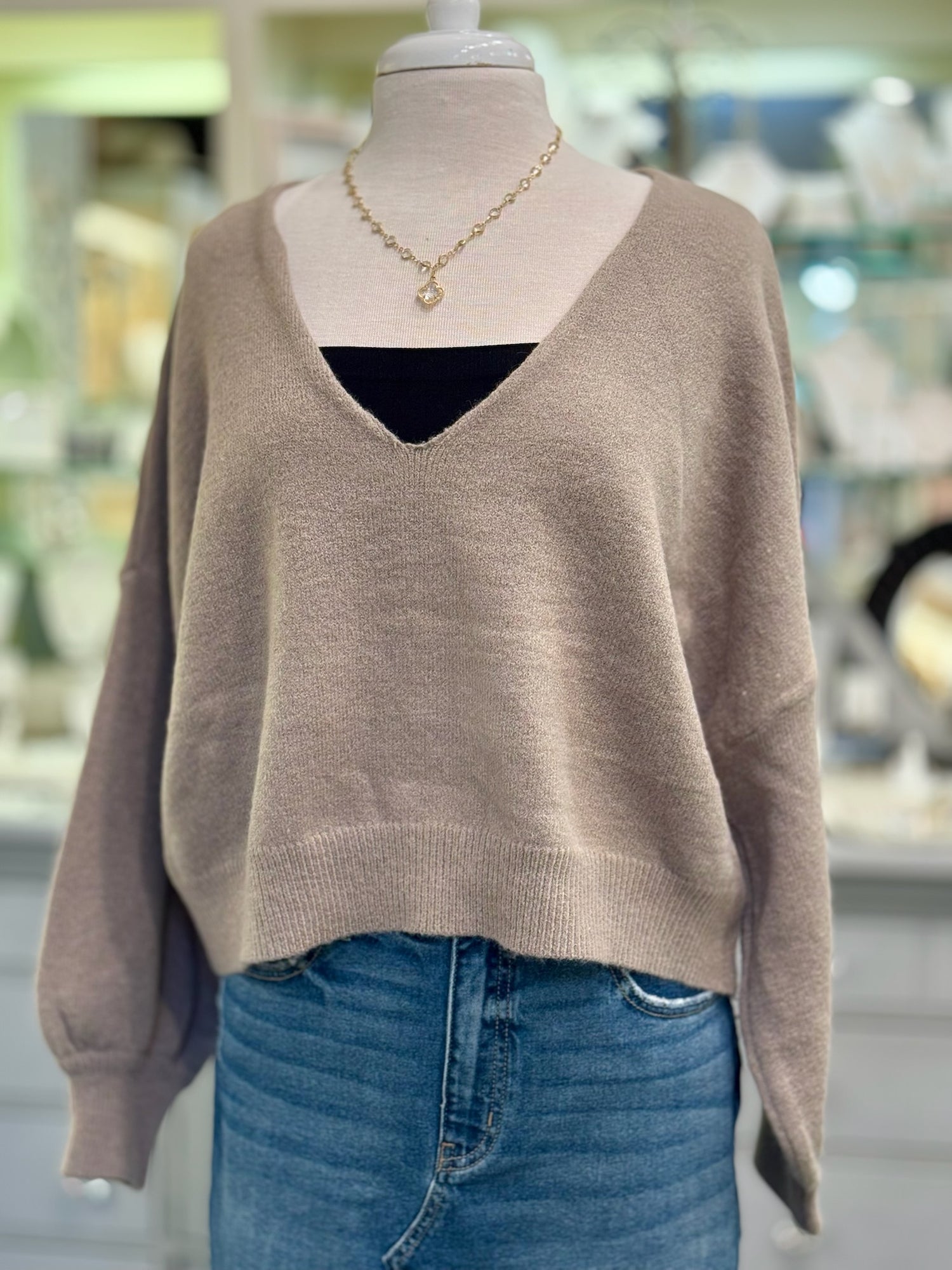 Front view of Ren Reversible Cropped Sweater in mocha worn with bandeau, showing V neckline.