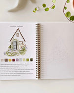 Open Garden watercolor workbook by Emily Lex showing a garden cottage painting example with step by step instructions and a sketch page to paint