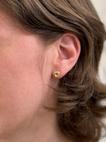 Gold Knot Stud Earrings being worn